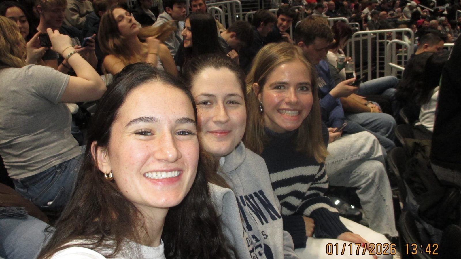 Three young women at a basketball game