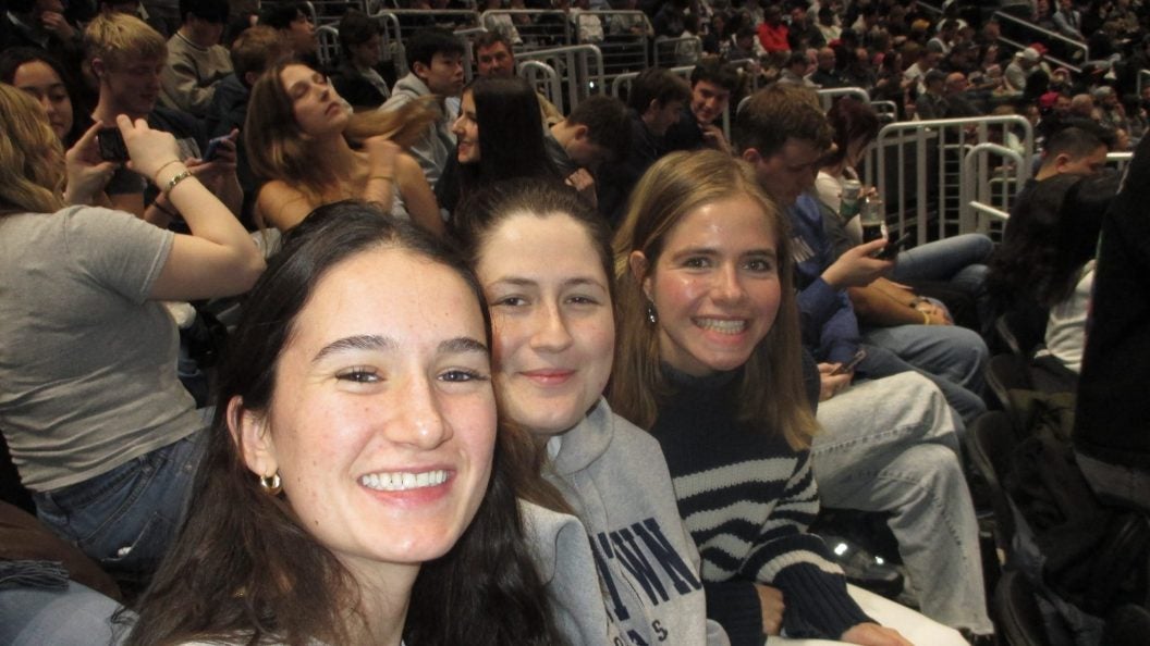 Three young women at a basketball game