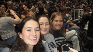 Three young women at a basketball game