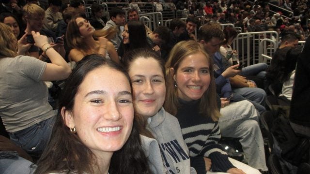 Three young women at a basketball game