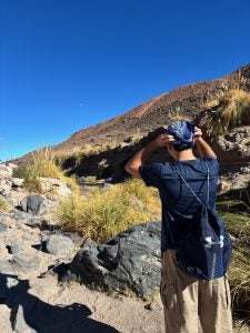 A student hikes a trail wearing a backpack