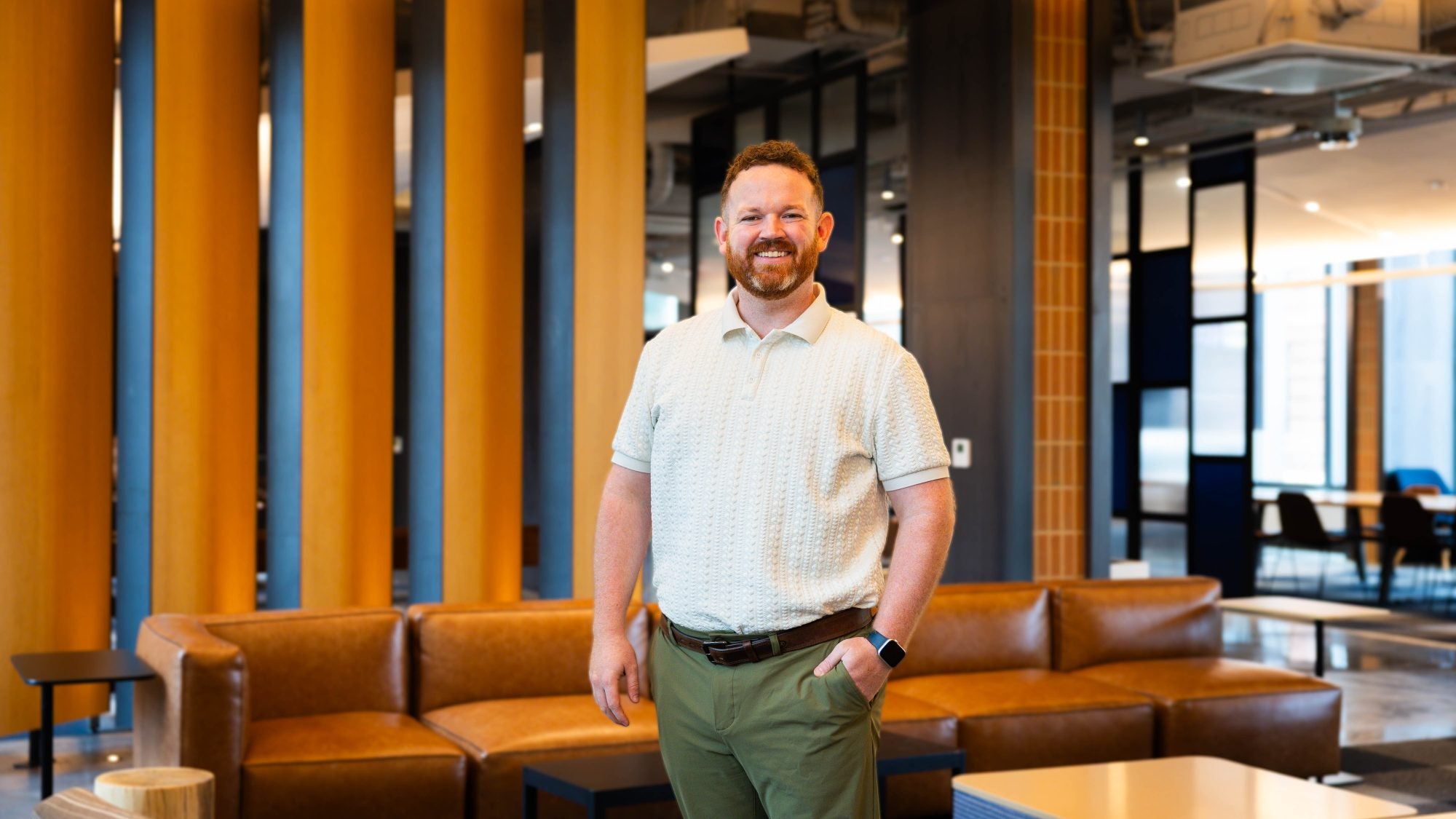 Man smiling inside a lobby