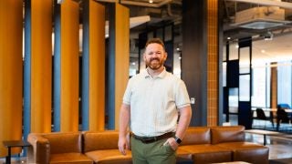 Man smiling inside a lobby