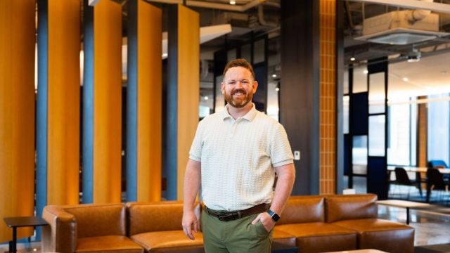 Man smiling inside a lobby