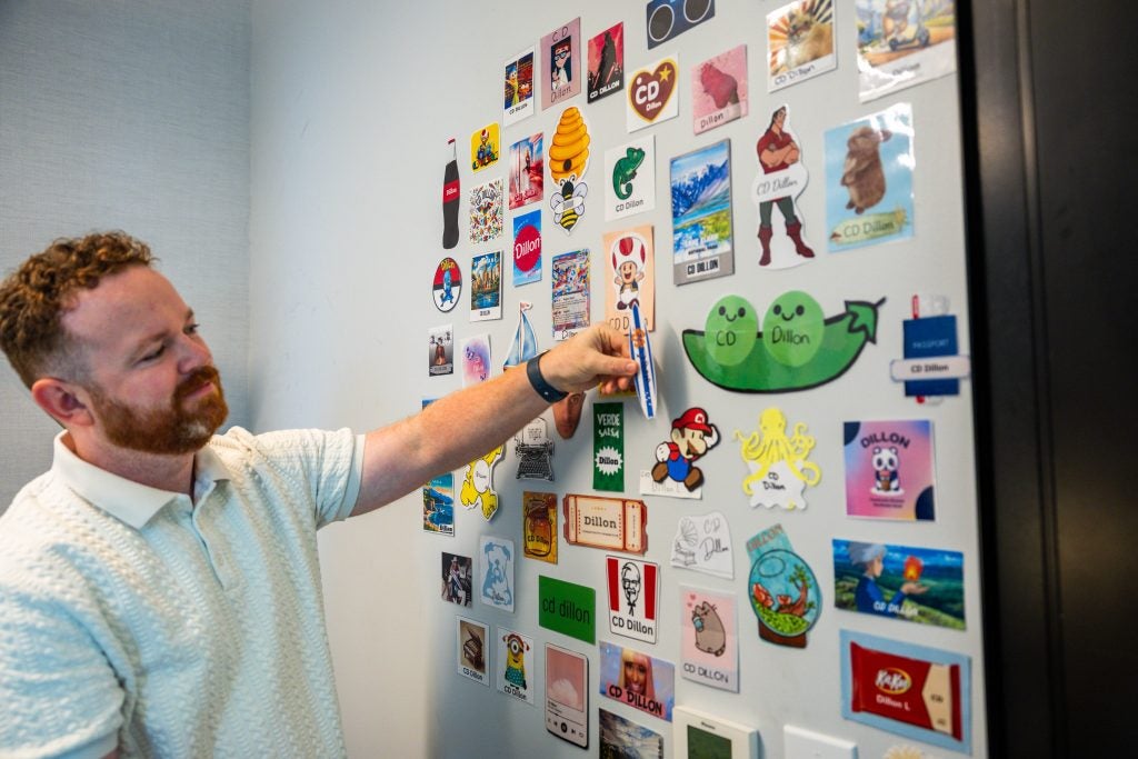 Man pointing to a wall with stickers