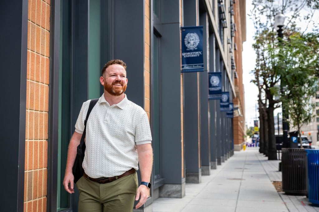 Man walking with a backpack outside
