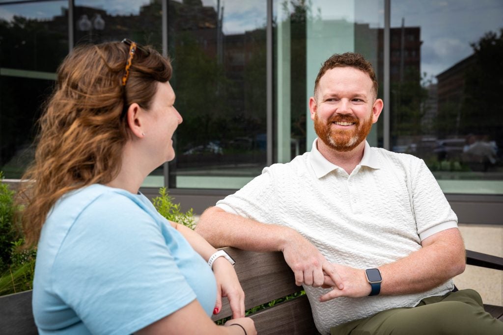Man with woman talking on bench