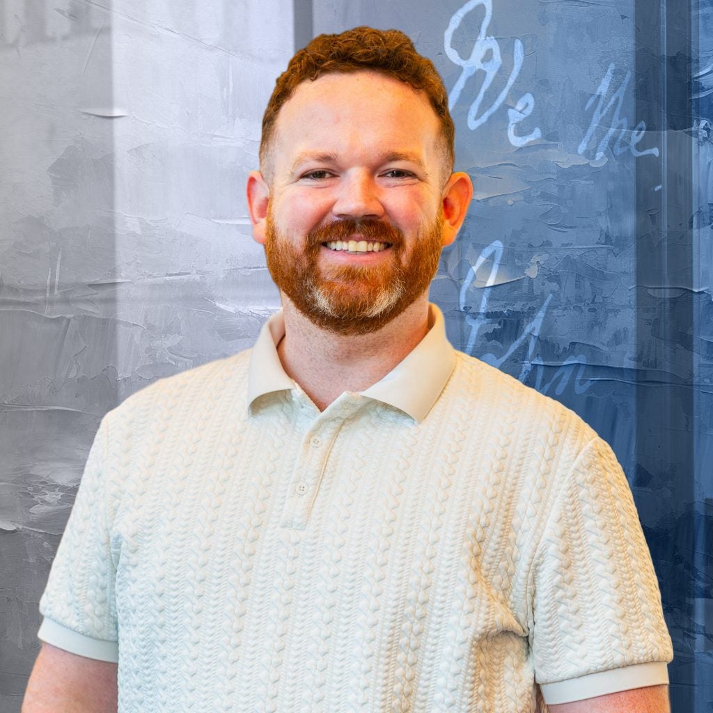Man smiling in a button down shirt