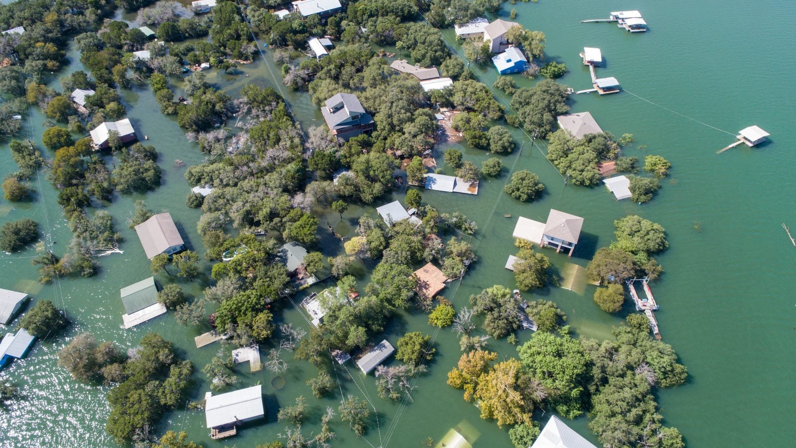 Historic Flooding in Central Texas Homes under water at Graveyard Point neighborhood community in the flood plain of Lake Travis , Aerial drone view entire Neighborhood under water near Austin , Texas
