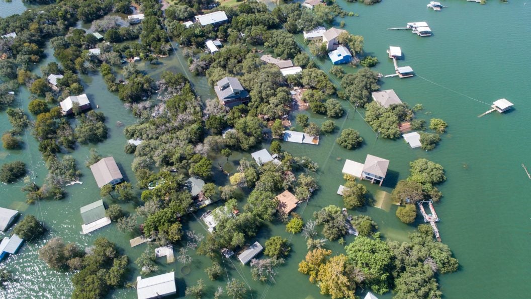 Historic Flooding in Central Texas Homes under water at Graveyard Point neighborhood community in the flood plain of Lake Travis , Aerial drone view entire Neighborhood under water near Austin , Texas