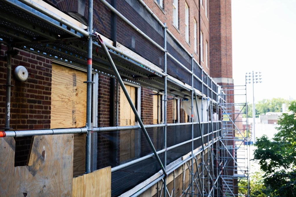 Construction panels alongside the exterior of a building.