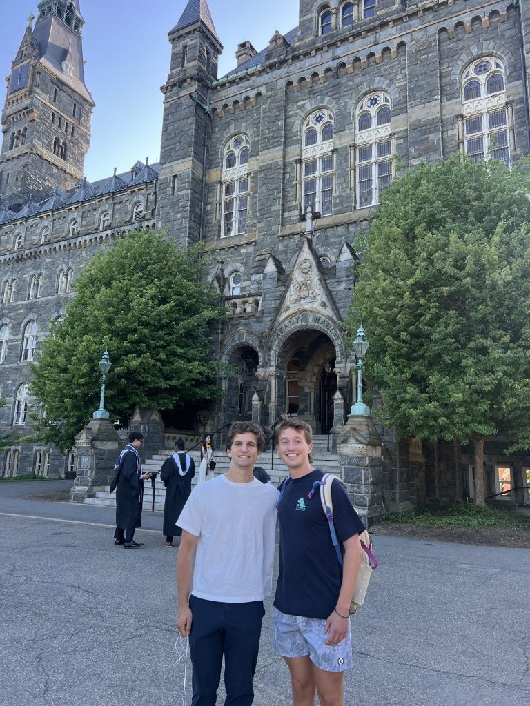 Two young men in front of Healy Hall
