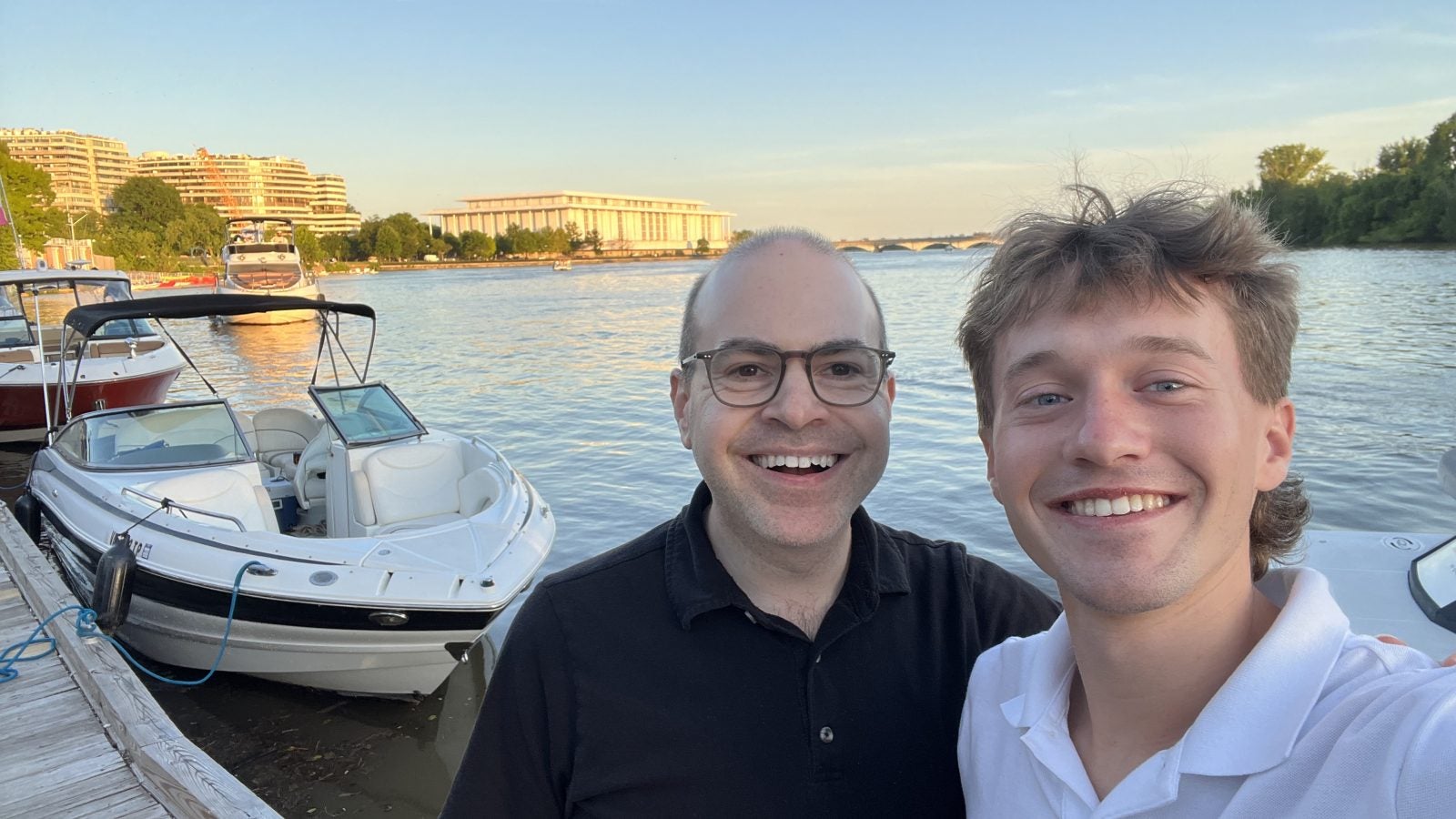 Two Caucasian men along the Georgetown waterfront on a clear day