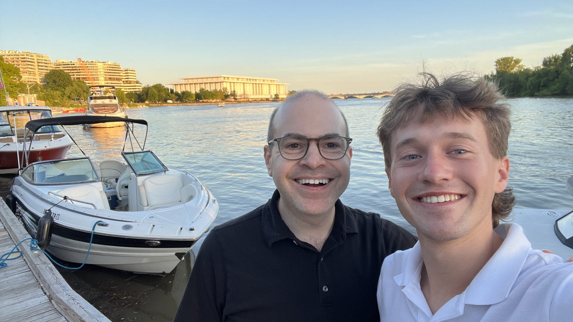 Two Caucasian men along the Georgetown waterfront on a clear day
