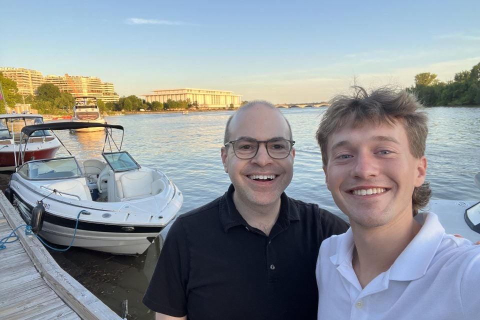 Two Caucasian men along the Georgetown waterfront on a clear day
