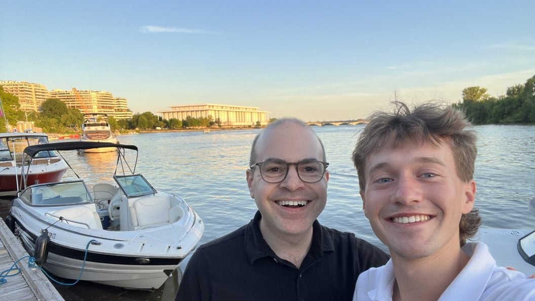 Two Caucasian men along the Georgetown waterfront on a clear day