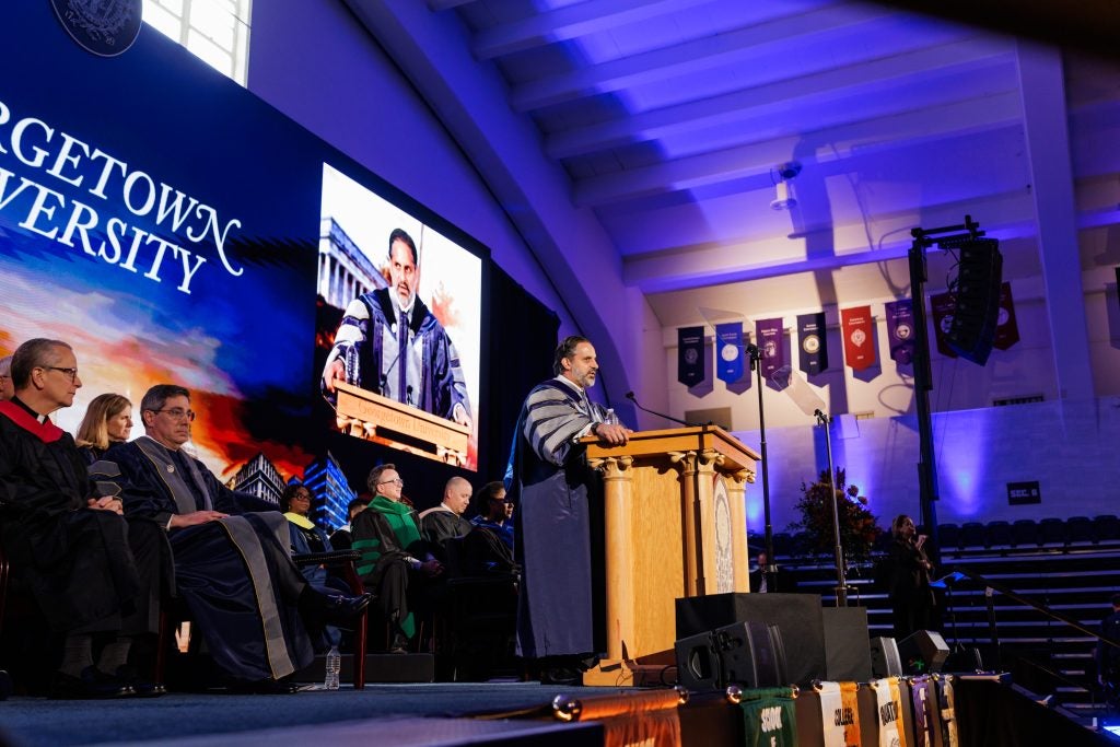 President Peñalver speaks from behind a podium onstage