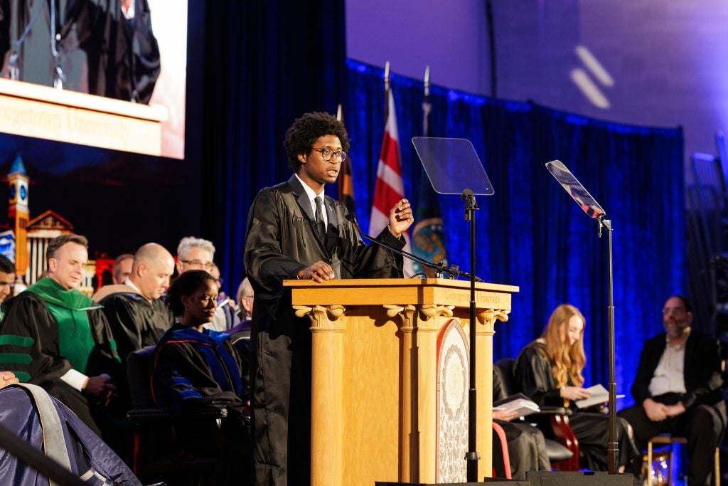 A student speaks from behind a podium