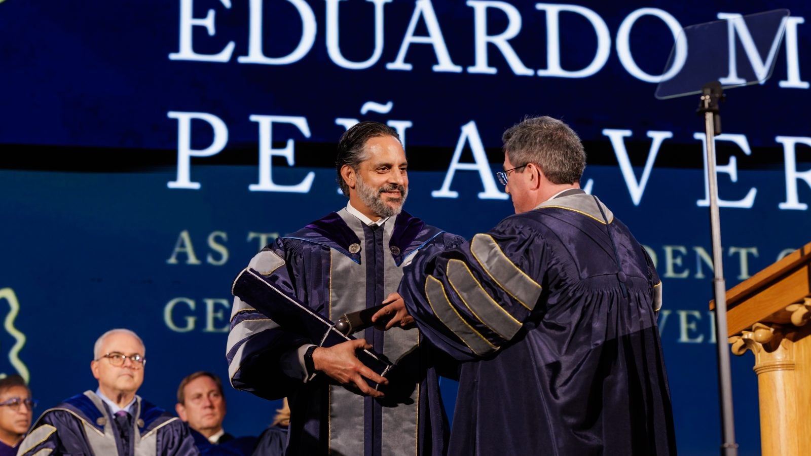 Georgetown President Peñalver accepts a mace while onstage