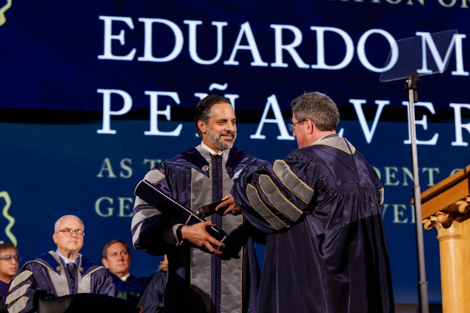 Georgetown President Peñalver accepts a mace while onstage