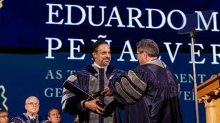 Georgetown President Peñalver accepts a mace while onstage