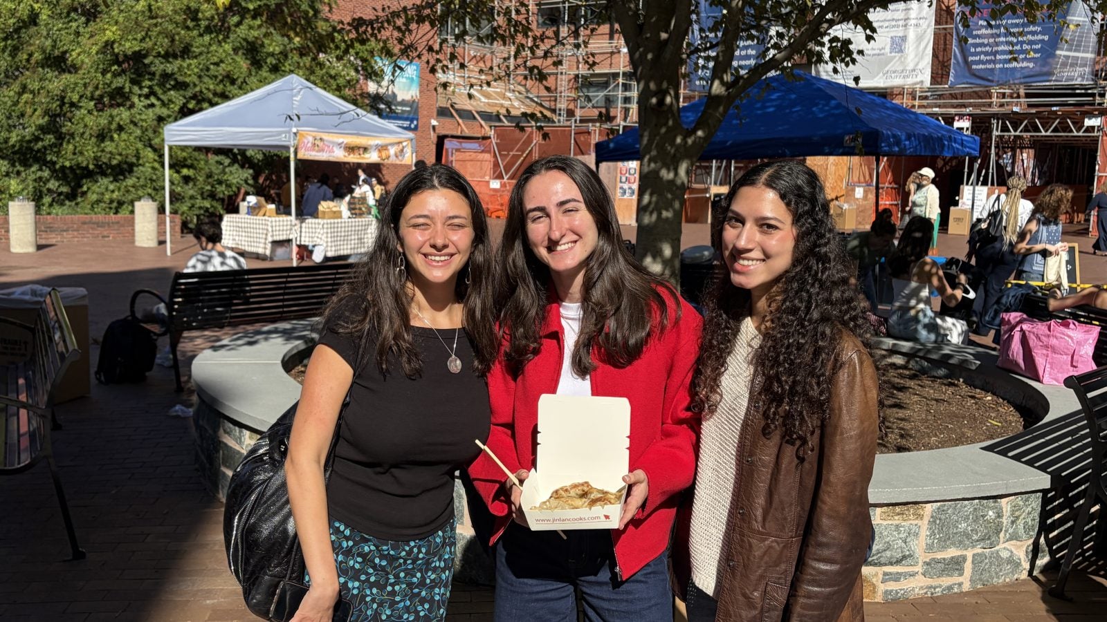 Three young women at the GU farmers market