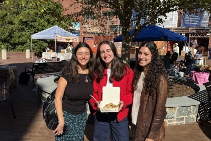 Three young women at the GU farmers market