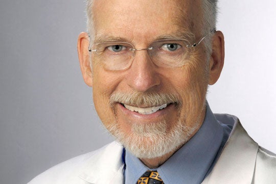 Dr. Ross Fletcher smiles in a headshot.