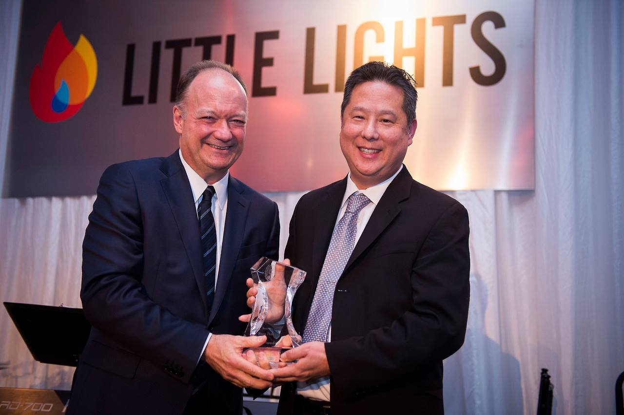 Steve Park holds his Legacy of a Dream Award and and stands with John J. DeGioia 
