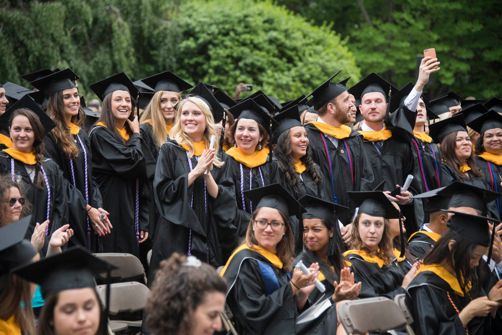 NHS graduates sitting and standing