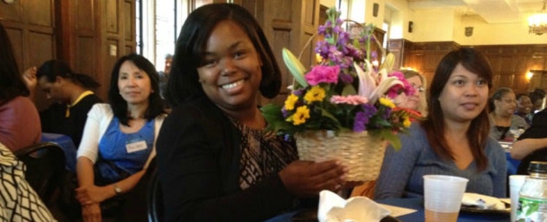 Angela Yates holds up a flower arrangement she won during Georgetown's Administrative Professionals Breakfast.