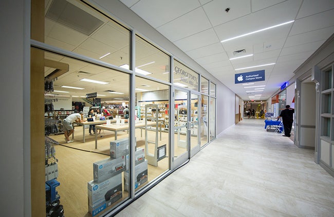 Salespeople work in the new section of the Apple Authorized Campus Store located in the Leavey Center