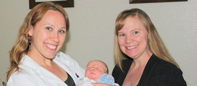 Erin Johnson holds Melissa Wilmarth's newborn baby Jared Wilmarth V and Melissa stands next to them