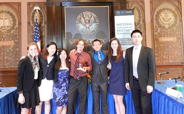 Joelle Rebeiz, Minjung Koo, Laura Zhang, Colin Hickey, Michael Vu, Maggie Cleary and Tiancheng Huang stand in Gaston Hall