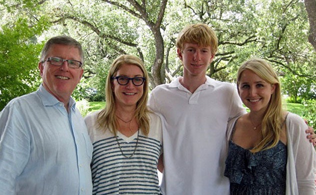 The Booth Family stands outside under a tree