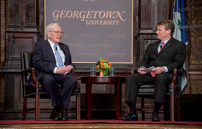 Warren Buffett sits on stage with Brian Moynihan.