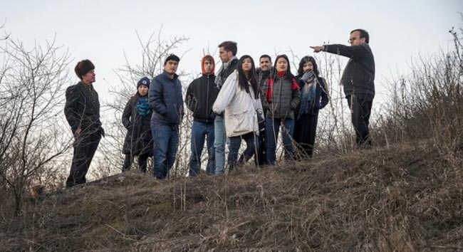 Rev. Patrick Desbois talks with his students while visiting Moldova as part of his mission to discover unmarked mass graves.