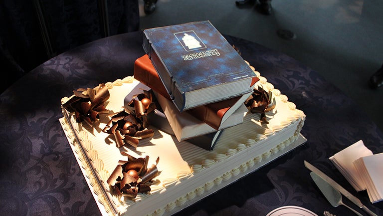 200th anniversary cake topped with a stack of Georgetown University books as decoration.