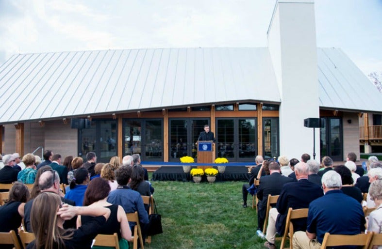 About 100 students, alumni, university leaders and Clarke County neighbors gather in front of the Pedro Arrupe Community Center.