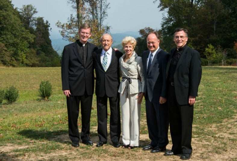 Arthur and Nancy Calcagnini pose with Rev. Philip Boroughs, President John J. DeGioia, and Rev. Kevin O'Brien, S.J.