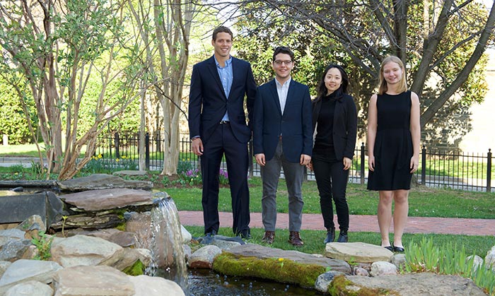 Four of the 13 Clinton Global Initiative students stand together outside