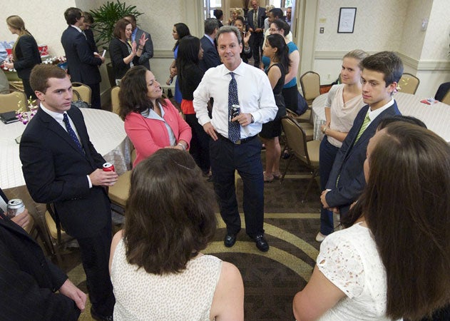 Glen Walter speak with a circle of Georgetown students during a visit to campus.