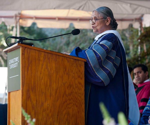 Ela Bhatt speaks at podium on stage on Healy Lawn