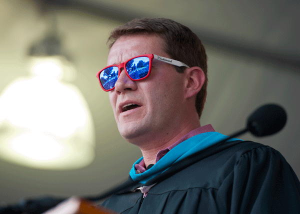Scott Case wearing sunglasses while speaking