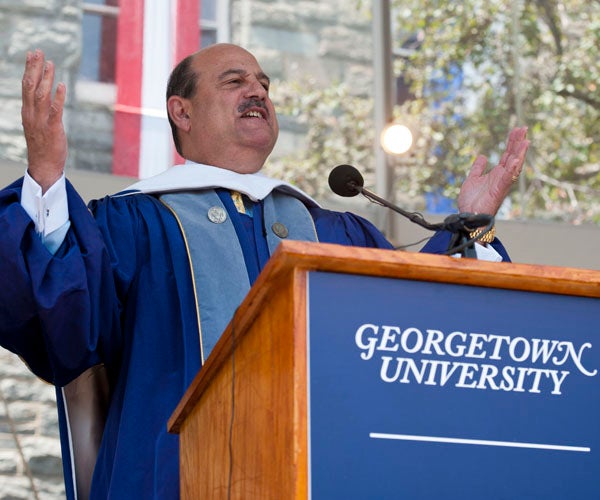 Barry Salzberg speaks at podium on stage on Healy Lawn