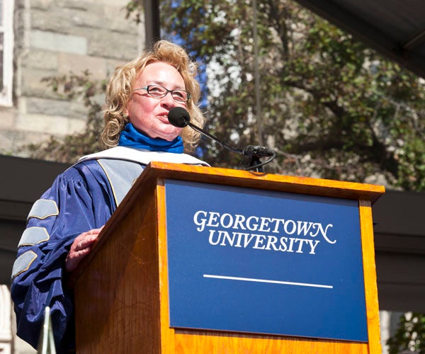 Helen Neville speaks at podium on stage on Healy Lawn