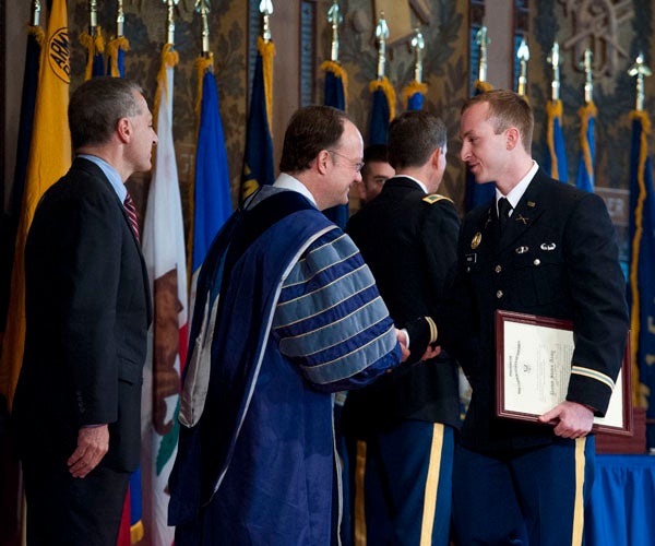 Sean Freeh shakes hands with John J. DeGioia in Gaston Hall