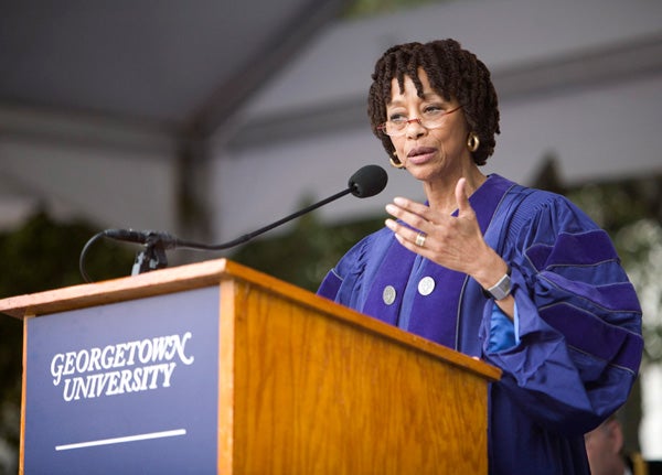 Gay McDougall speaks at podium on stage on Healy Lawn