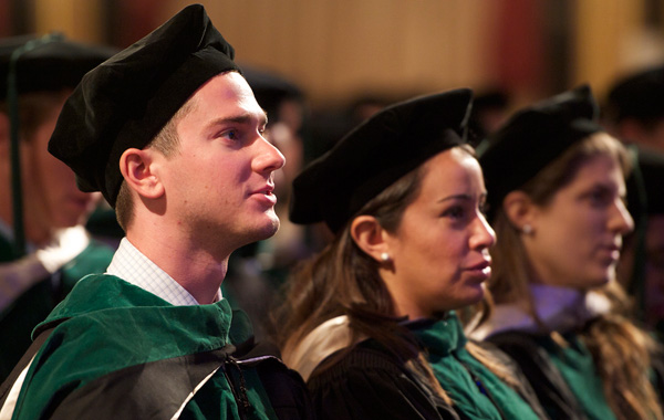 Medical School Graduates look on during ceremony