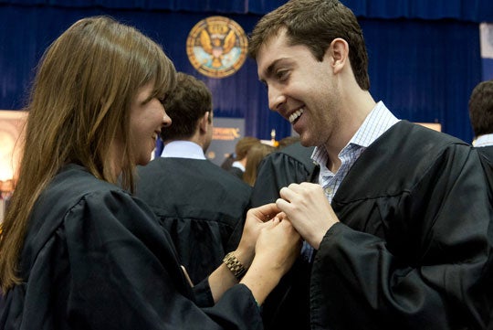 Students pin one another with their official Georgetown alumni pins at 2012 Senior Convocation